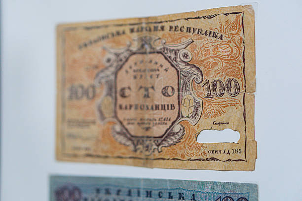 istock Historical, aged Ukrainian banknote pasted on a surface Features a portrait and intricate patterns in blues, greens, purples, and yellows Shows both left and right sides with 3D effect under natura 2212622128