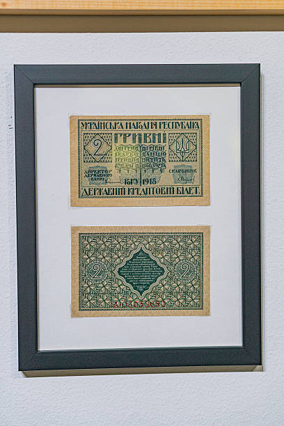 istock Historical, aged Ukrainian banknote pasted on a surface Features a portrait and intricate patterns in blues, greens, purples, and yellows Shows both left and right sides with 3D effect under natura 2212622275