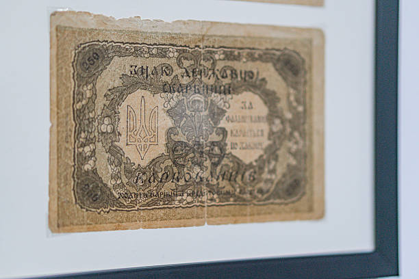 istock Historical, aged Ukrainian banknote pasted on a surface Features a portrait and intricate patterns in blues, greens, purples, and yellows Shows both left and right sides with 3D effect under natura 2212622276