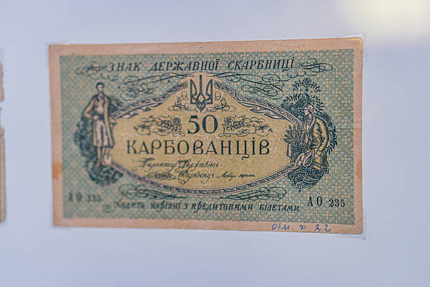 istock Historical, aged Ukrainian banknote pasted on a surface Features a portrait and intricate patterns in blues, greens, purples, and yellows Shows both left and right sides with 3D effect under natura 2212622521