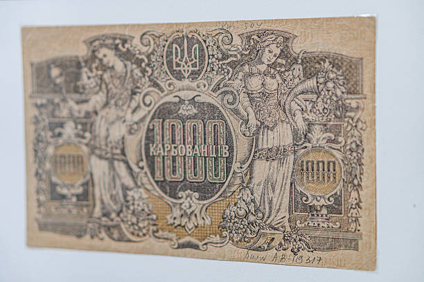 istock Historical, aged Ukrainian banknote pasted on a surface Features a portrait and intricate patterns in blues, greens, purples, and yellows Shows both left and right sides with 3D effect under natura 2212622523