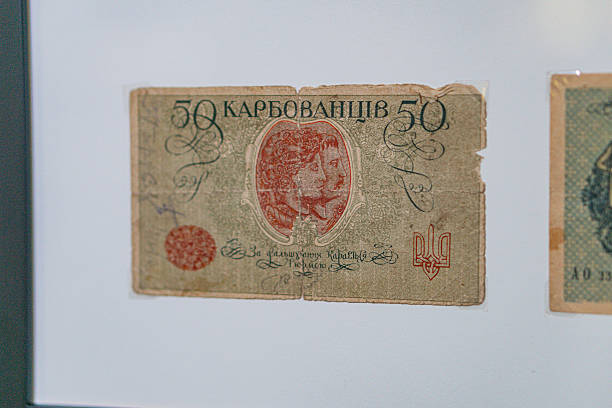 istock Historical, aged Ukrainian banknote pasted on a surface Features a portrait and intricate patterns in blues, greens, purples, and yellows Shows both left and right sides with 3D effect under natura 2212622525