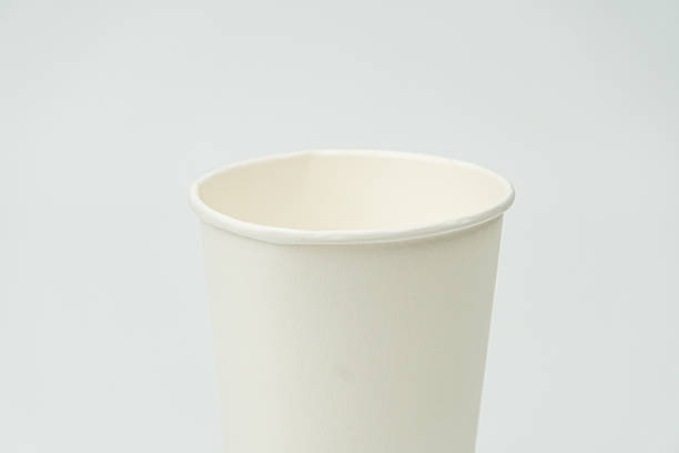 istock Light gray surface holds a white, ceramic or porcelain cup with rounded edges The cup is angled slightly, revealing its inner curve No additional items are visible within the photograph, taken indo 2212624325