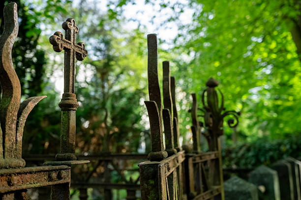Wrought iron gate with a Religious Cross and sharp points isolated on white background and copy space. Brescia, Lombardy, Italy, Europe.