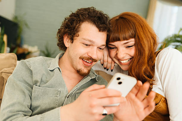 istock Couple interacting together on their mobile phone 2212633394