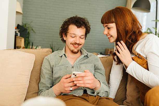 istock Couple interacting together on their mobile phone 2212633478