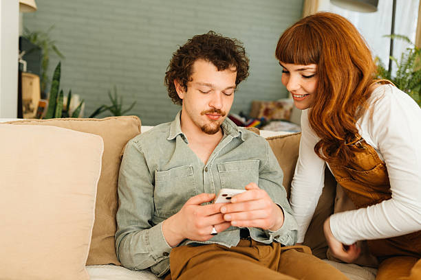 istock Couple interacting together on their mobile phone 2212633496