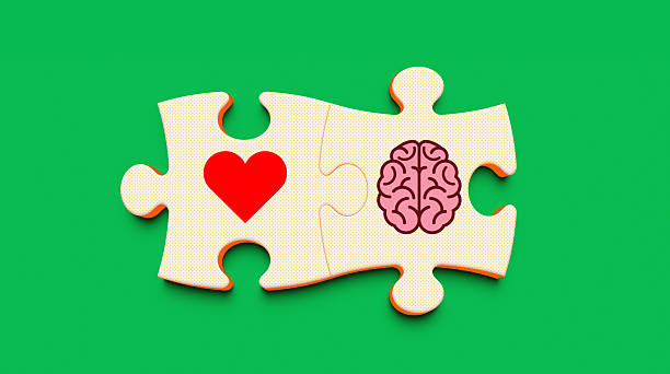 Two jigsaw puzzle pieces, one with a heart symbol and one with a brain symbol, connecting on a green textured background. Represents the balance between emotion and logic, emotional intelligence, decision making, and the connection of feelings and reason. Paper cut style.