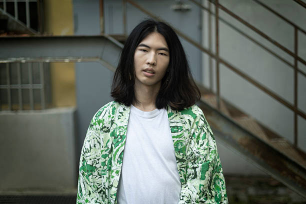 istock Young man posing with stylish green overcoat in urban setting 2212635648