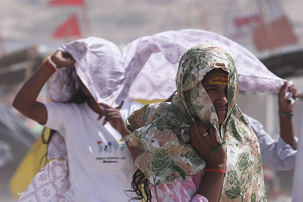 Indian people brave heat wave conditions during a hot summer day  at the banks of Sangam( confluence of River Ganges, Yamuna and mythical Saraswati ) in Prayargaj , India.  Parts of northern India have been gripped by a heatwave , with temperatures soaring near  45 degrees Celsius (113 degrees Fahrenheit).