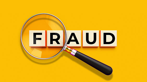 istock Fraud Detection Magnifying Glass Wooden Blocks Concept Yellow 2212636481