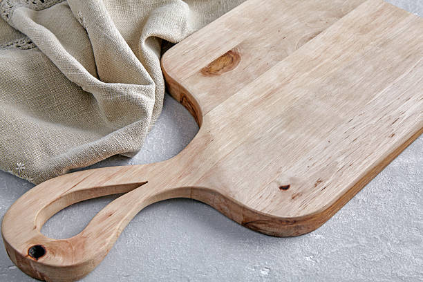 istock wooden cutting board and linen tablecloth on grey concrete table front view 2212636838
