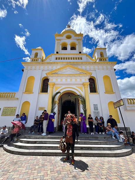 Quito, Pichincha, Ecuador - April 18, 2025: Traditional devil dancer wearing a colorful mask and costume stands before a church in La Merced. Ecuador. During the Good Friday Semana Santa procession. Blending indigenous and Catholic traditions
