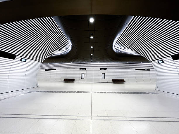 istock A futuristic tunnel featuring tiled floor, modern white striped walls and black ceiling provide a well designed public space for the future 2212649737