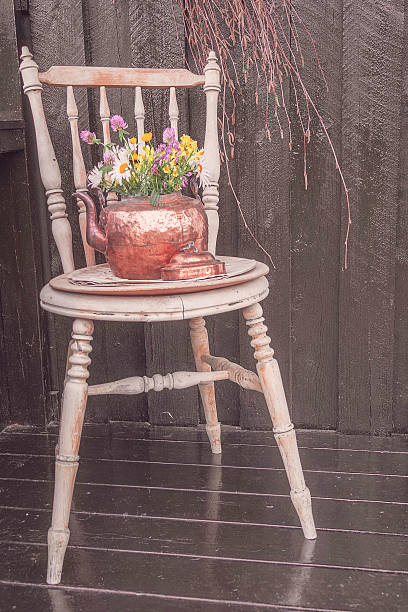 istock flower vase on vintage chair 2212649744