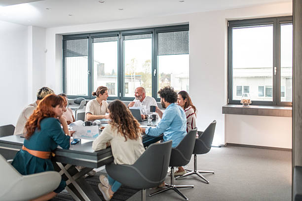 istock Diverse Team Engaging in Collaborative Brainstorming in Modern Office 2212651409