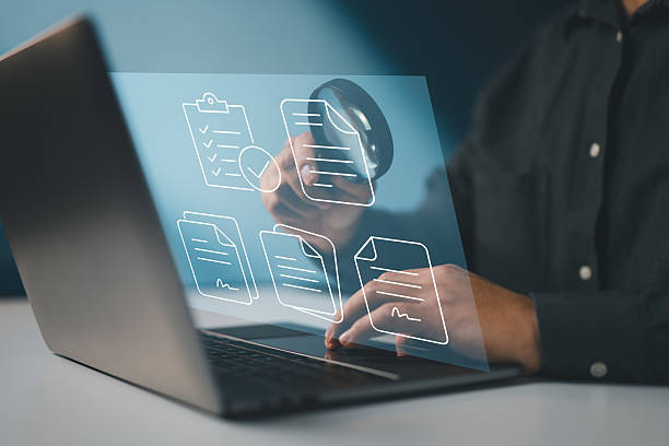 istock Symbolizes a digital audit process involving thorough inspection of electronic documents and records. 2212653013