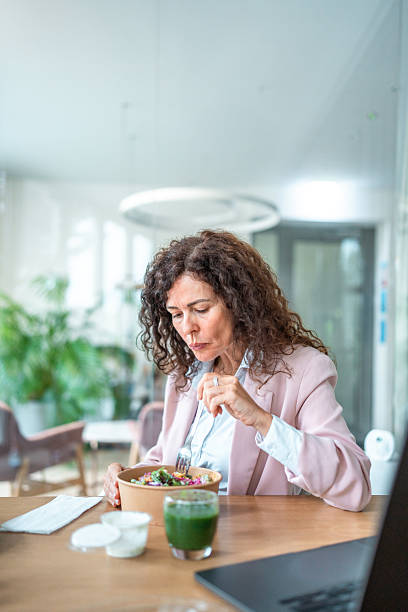 istock Businesswoman Enjoying Lunch Break in Modern Office 2212659902