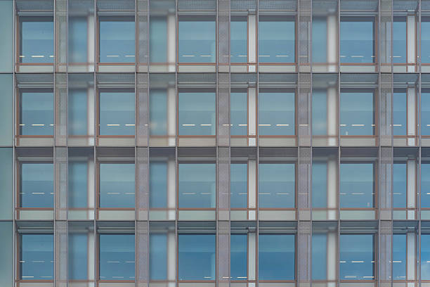 istock glass curtain wall facade of a modern building, with the sky reflected on its surface. 2212665754