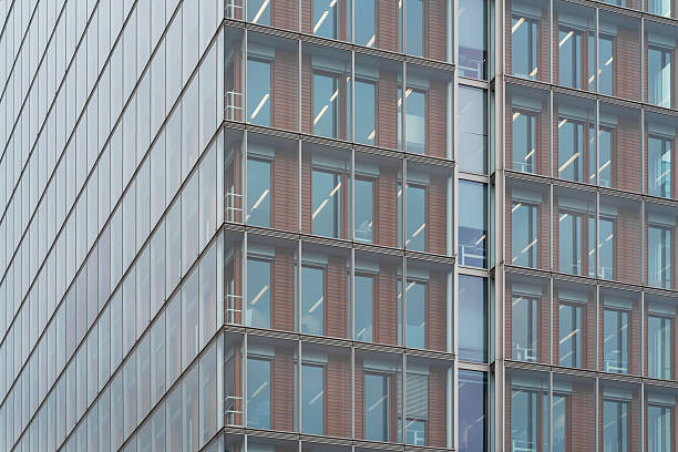 istock glass curtain wall facade of a modern building, with the sky reflected on its surface. 2212665783