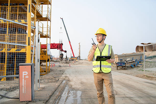 istock asian male engineer working with digital tablet in construction site 2212667545