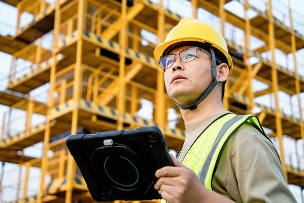 istock asian male engineer working with digital tablet in construction site 2212667653