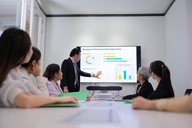 istock Asian Malay businessman showing and explaining Charts, Statistics, and Data to colleagues in a business meeting stock photo 2212672099
