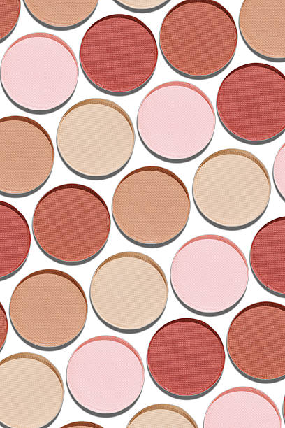 istock Swatches eyeshadow refills as minimal geometric pattern on white. Pastel matte pans brown beige nude shades with sun shadows, detailed texture, cosmetic, beauty concept makeup, top view layout 2212672247
