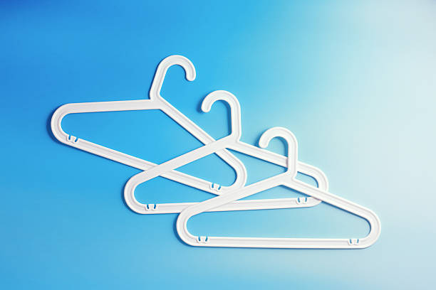 istock White Clothes hangers as creative minimal composition gradient background of blue color, Plastic racks creating modern and geometric aesthetic, top view photo vivid color, creative modern pattern 2212672258