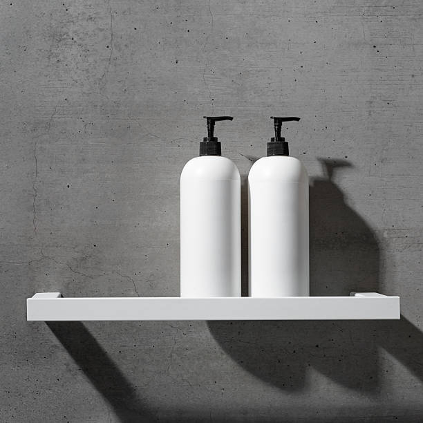 istock White bottles mock up on white shelf on gray concrete background, close up shampoo, conditioner. Aesthetic view beauty products in modern minimal bathroom neutral color. Side view, copy space 2212672281