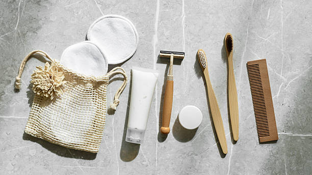 istock Hygiene products as bamboo toothbrushes, toothpaste, reusable pads, safety razor on grey marble, banner with natural light, eco-friendly items for self care, zero waste concept. Minimal style 2212672287