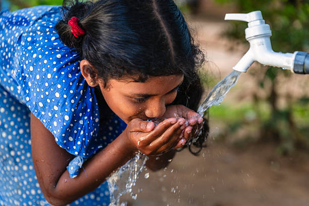 istock Sri Lankan young girl drinking a water, Ceylon 2212674359