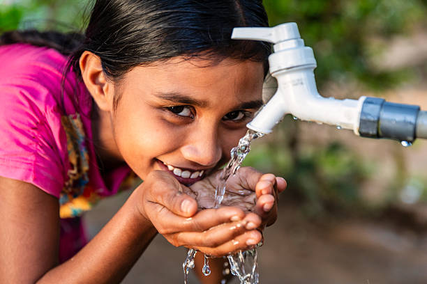 istock Sri Lankan young girl drinking a water, Ceylon 2212674386