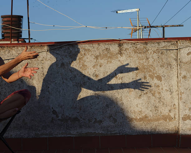 istock Engaging in Creative Shadow Play on an Urban Rooftop during the beautiful summer days 2212674660