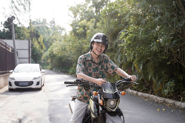 istock The boy riding a motorcycle on the road 2212674701