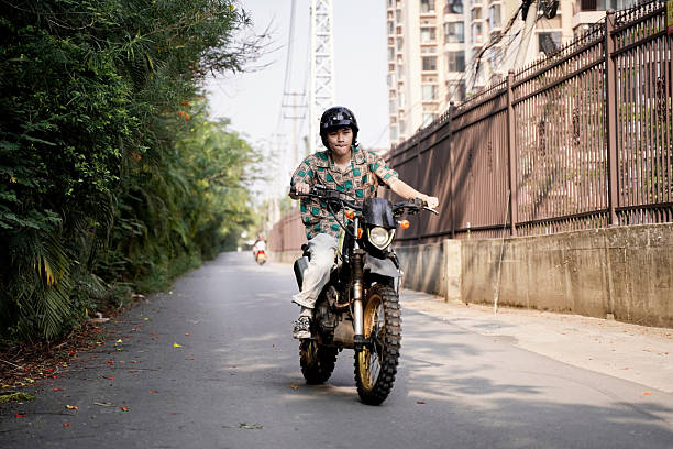 The boy speeding along the road on a motorcycle