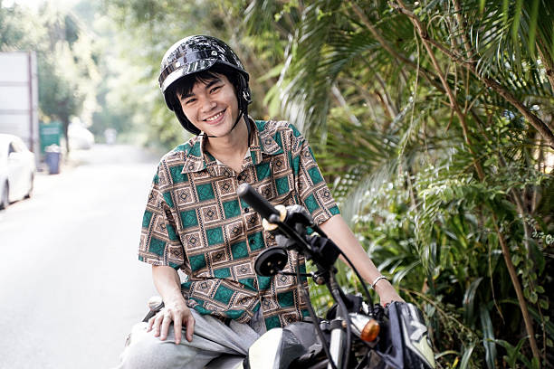 The boy speeding along the road on a motorcycle