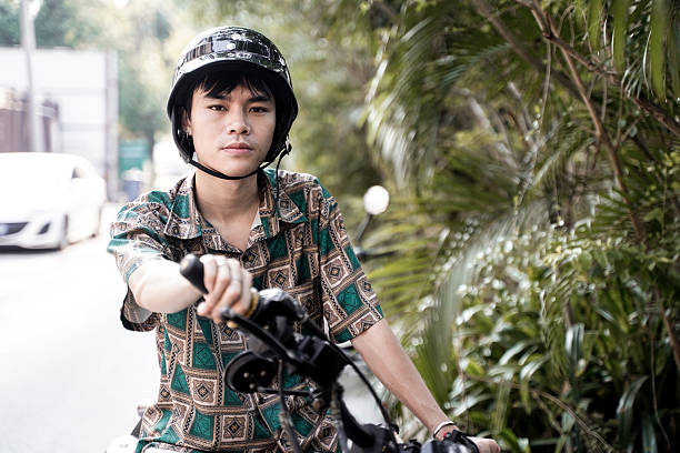 The boy speeding along the road on a motorcycle