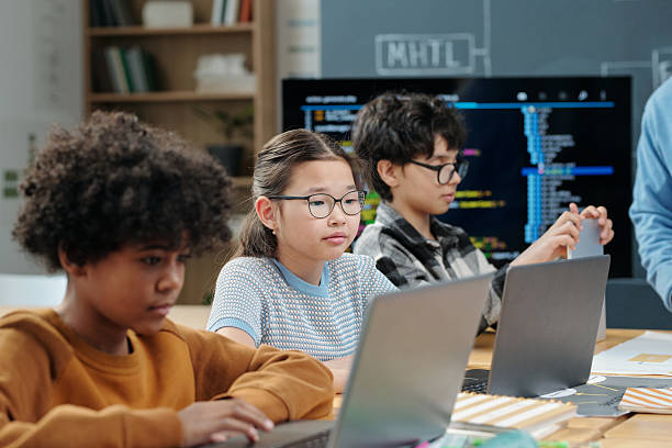 istock Group of Children Studying Together in Classroom 2212674873