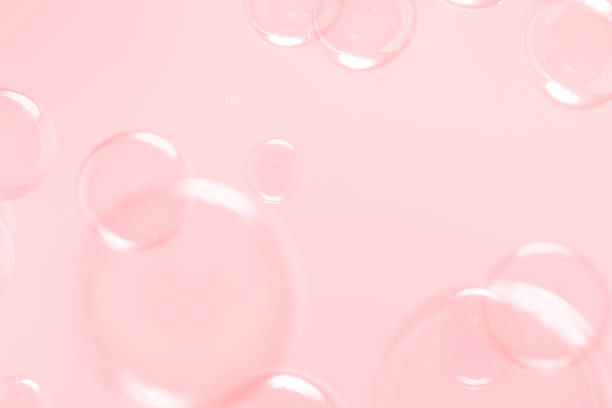 istock Beautiful Pink Soap Bubbles Floating in The Air. Celebration Festive Backdrop. Freshness Soap Suds Bubbles Water. Pink and White Gradient Textured. 2212675144
