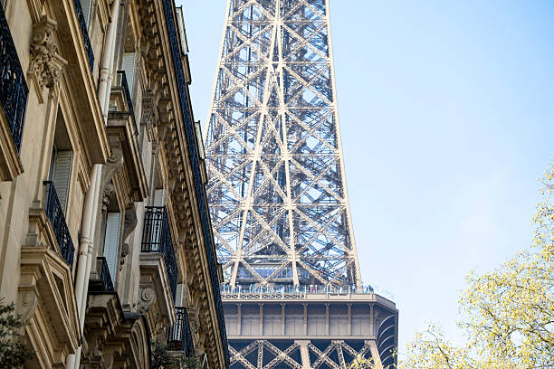 Eiffel tower against blue sky at morning. Photo made from pedestrian point of view. No people around