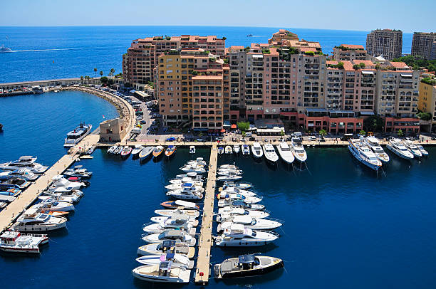 Stunning speed motor boats in Port Hercules in Monaco. Behind residential buildings on hill (maybe Monte Carlo  district) in sunny summer day!