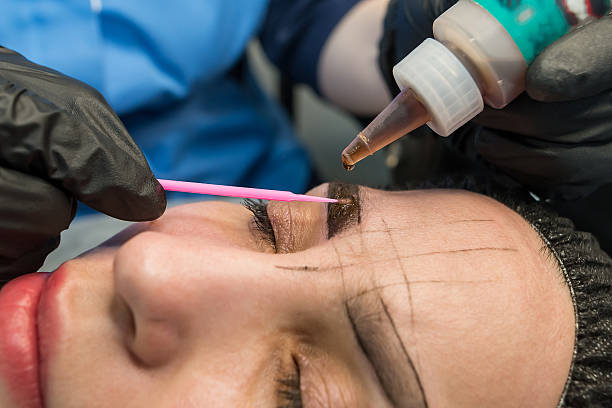 istock The cosmetologist makes a permanent makeup of the eyebrows on a woman's face. 2212677841
