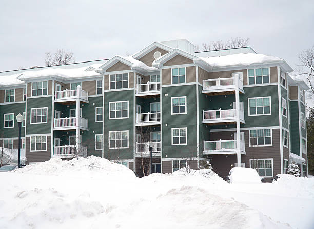 istock modern apartment building after winter snow storm 2212678635