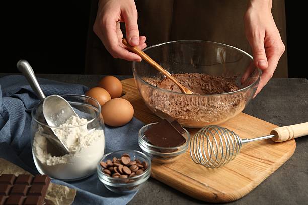 istock Woman making chocolate dough at grey table, closeup 2212678710