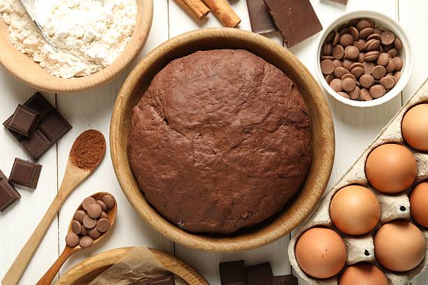 istock Chocolate dough and ingredients on white wooden table, flat lay 2212678712
