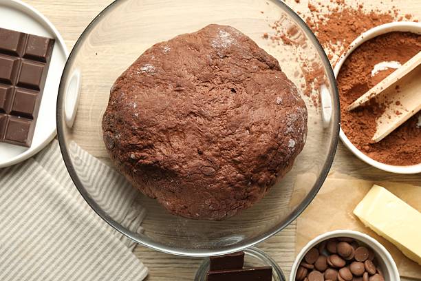 istock Chocolate dough and ingredients on wooden table, flat lay 2212678713
