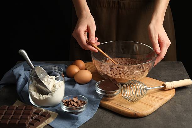 istock Woman making chocolate dough at grey table, closeup 2212678731