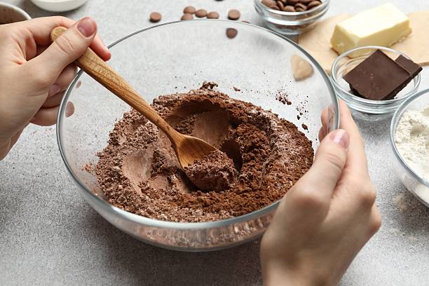 istock Woman making chocolate dough at light table, closeup 2212678743