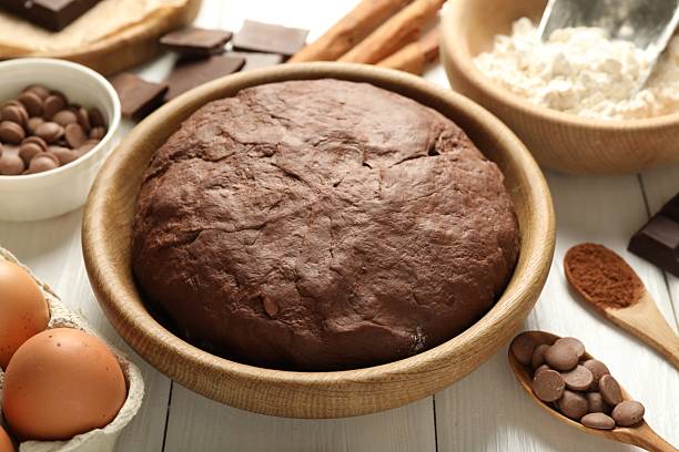 istock Chocolate dough and ingredients on white wooden table, closeup 2212678764